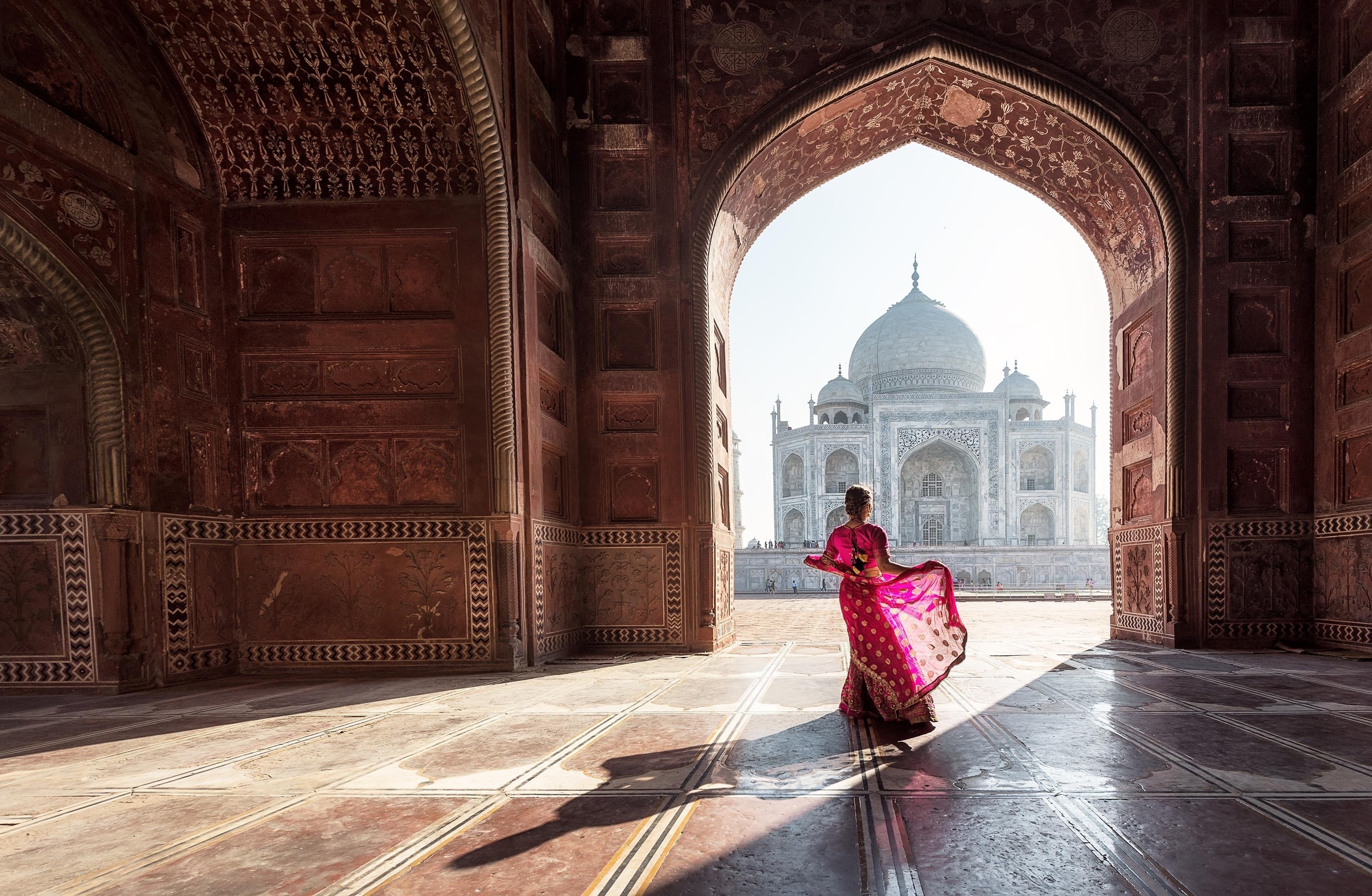 Woman in red saree/sari in the Taj Mahal, Agra, Uttar Pradesh, India. 